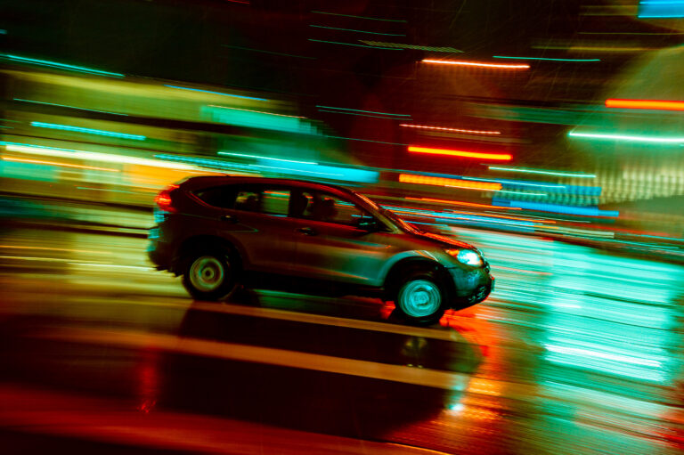 Slow Shutter Speed Panning shot of car with neon lights in Denver, Colorado