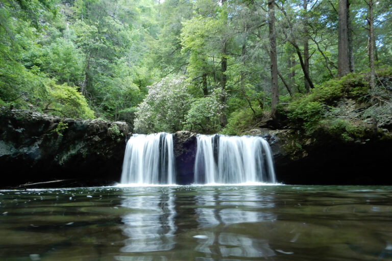 Long Exposure of a Tennessee Waterfall. Taken with Nikon Coolpix A900, for a camera review. Rippling water and trees in the woods.