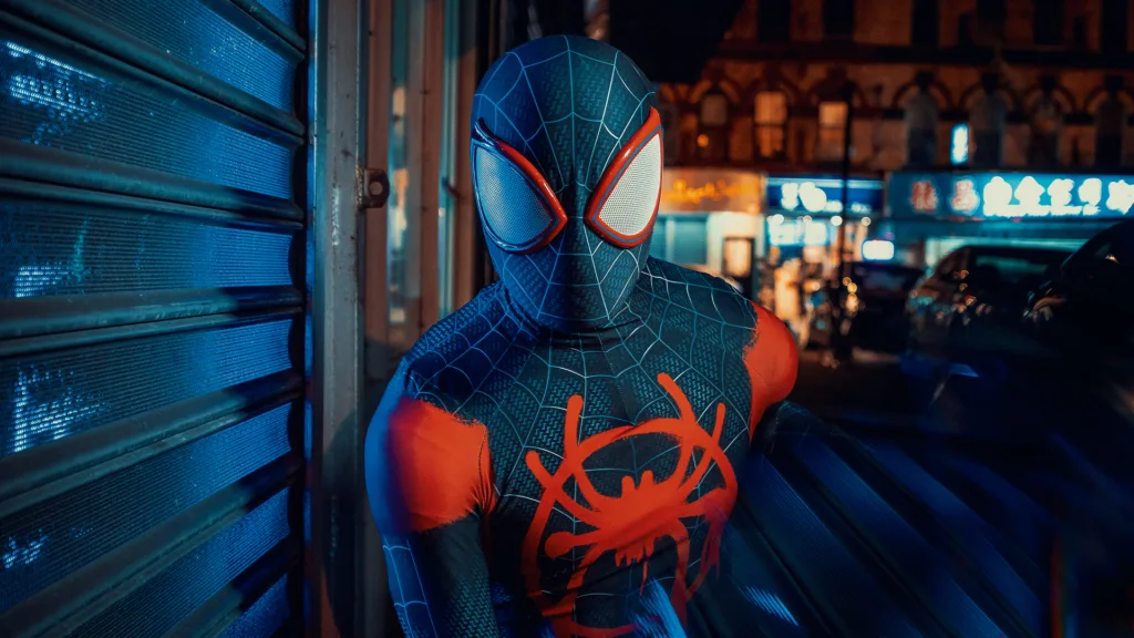 Spiderman cosplay in Manhattan NYC poses for a portrait in the streetlights.