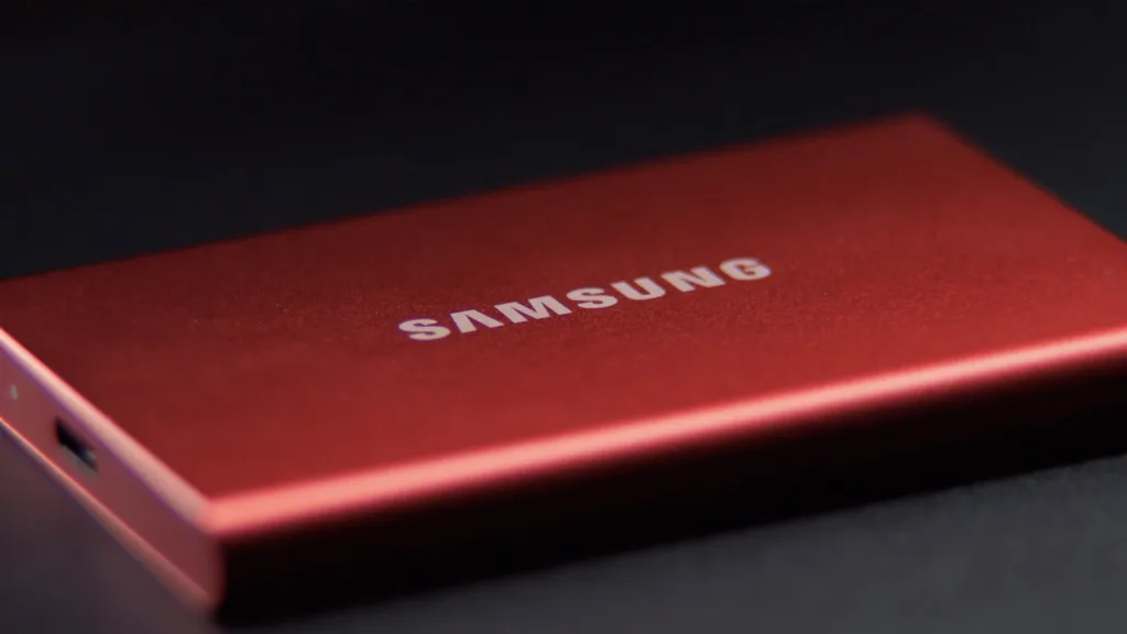 My Samsung T7 red ssd hard drive lays on a black table